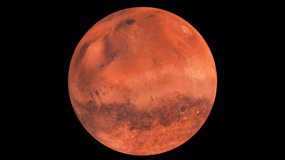  Czerwona planeta Mars na czarnym tle, ukazująca charakterystyczne powierzchniowe formacje, takie jak kraterowe struktury i marsjańskie równiny. Obraz symbolizuje eksplorację kosmosu oraz astrologiczne znaczenie Marsa.